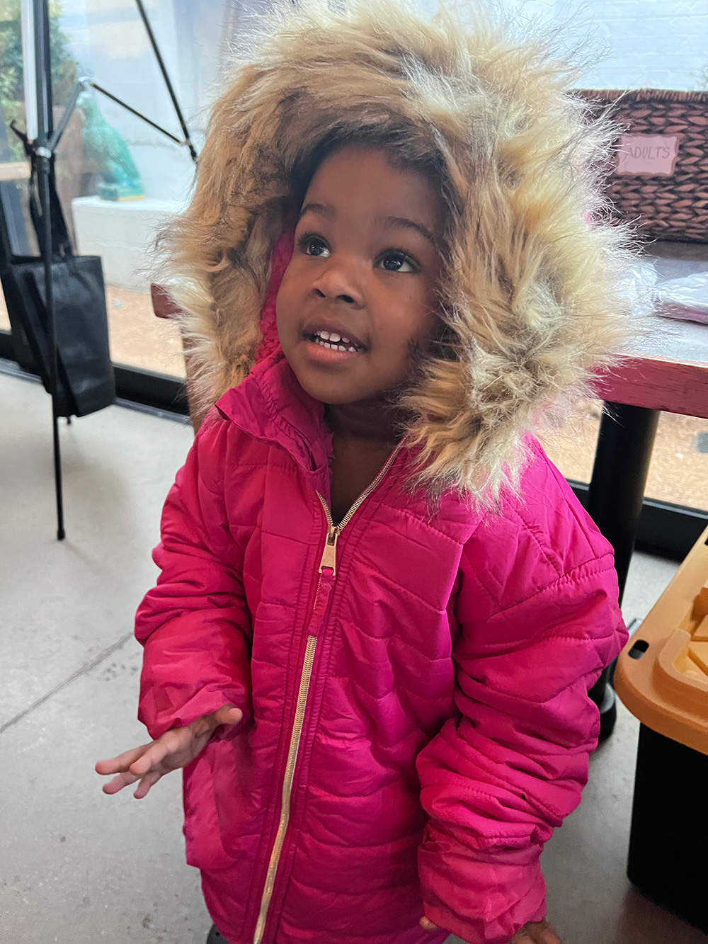 Photo of young girl with new pink coat.