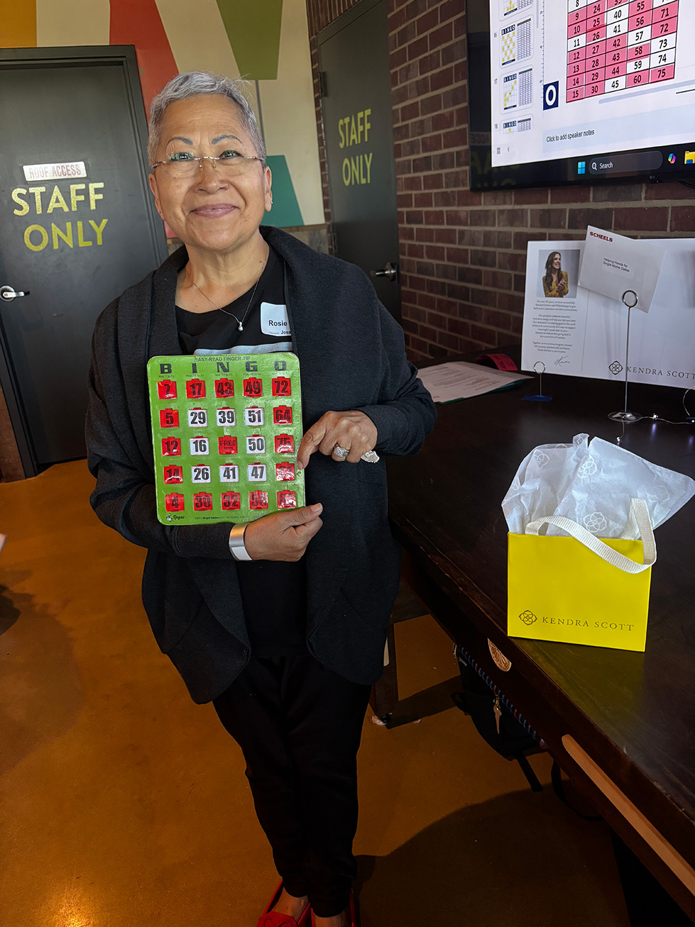 Bingo Night 2024 Happy bingo winner with bingo card and prize